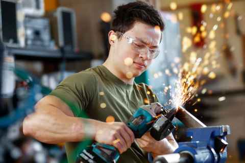 Logan working on the grinding machine