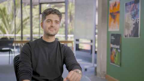 Nabeel sitting in teaching space for a interview.