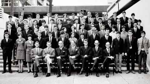 A large group of well-dressed people, in black and white.