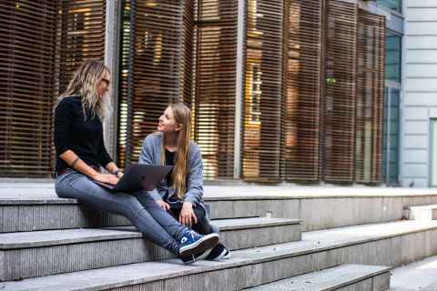 students talking on staircase
