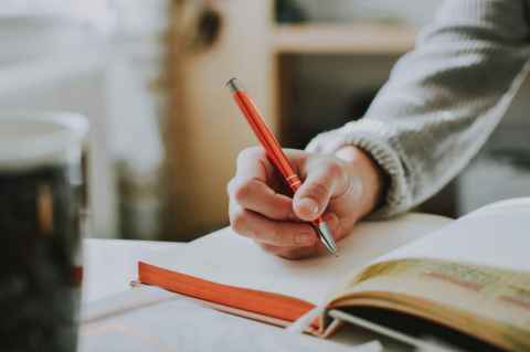 person writing in book