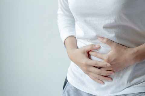 Person holding hands on stomach
