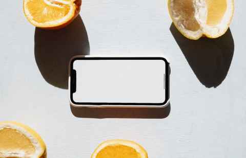 A smartphone surrounded by chunks of lemon.