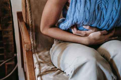 A woman holding her stomach.