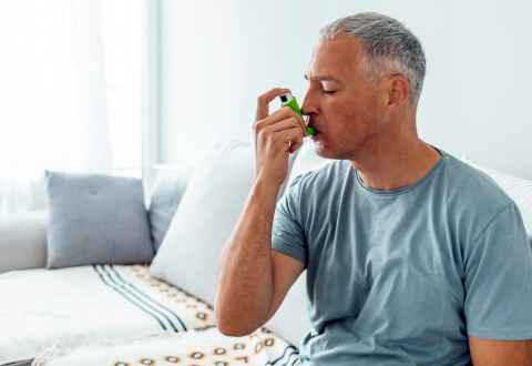 man with asthma using an inhaler