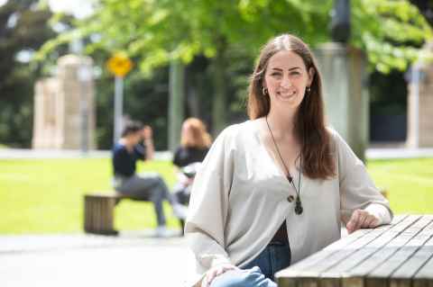 Spencer sitting at a picnic table outside