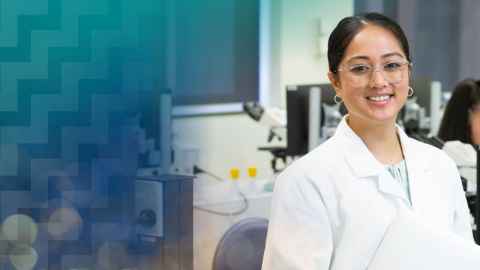 Woman in lab coat smiling