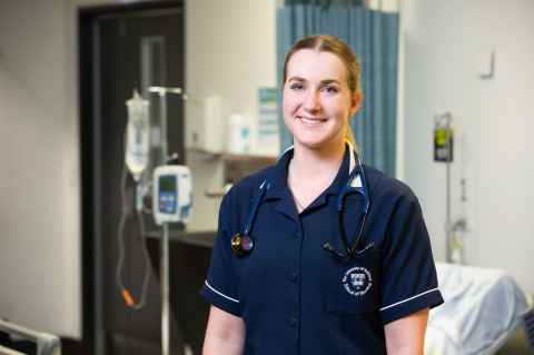 Woman standing in a hospital room