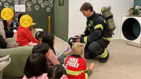 Children learning from a fireman