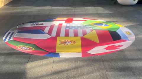 Football shaped decal filled with different flags outside Hiwa