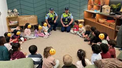 Two police men with children