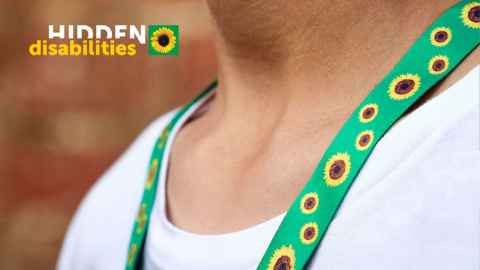 Photograph of a person wearing the sunflower lanyard