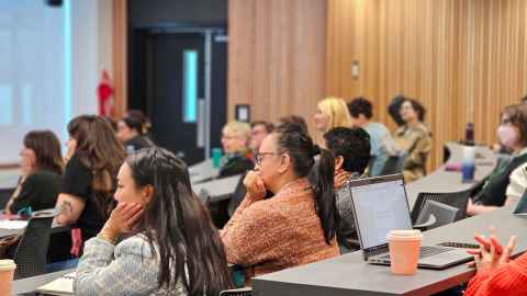 Staff members in a lecture theatre looking towards the stage