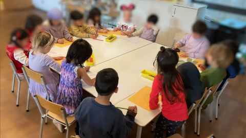 Children doing activities around the table