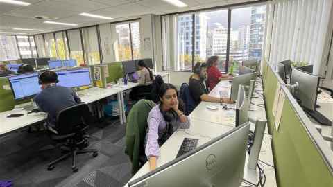 Photo of SEC representatives in an open-plan office. 