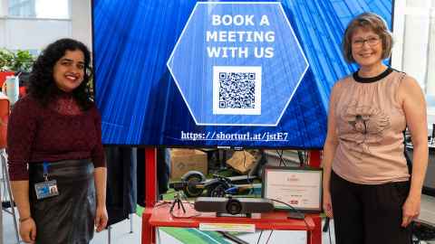 Digital coaches in front of a blue digital screen