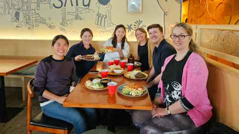 Group photo of the Risk team having lunch at a cafe. 
