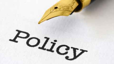 Photo of  a fountain pen nib with the word 'Policy' written beneath it. 