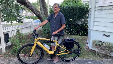 Photo of Gilbert Wong with his bicycle. 