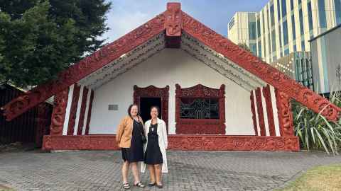 Photo of Abigail McClutchie and Manuhiri Huatahi outside Waipapa Marae. 