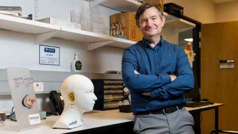 Photo of Professor Grant Searchfield in his office. 