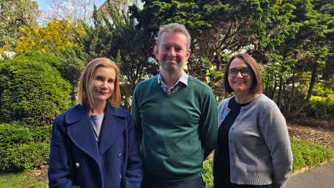 Photo of the Web team outside Old Government House. Jo Renfree (L), Frazer Orr (C), and Treena Brown (R)