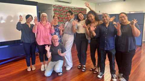 Photo of Dr Haruna Suzuki-Kerr (far left) and Naketa Phillips with members of the Deaf community they worked with. 
