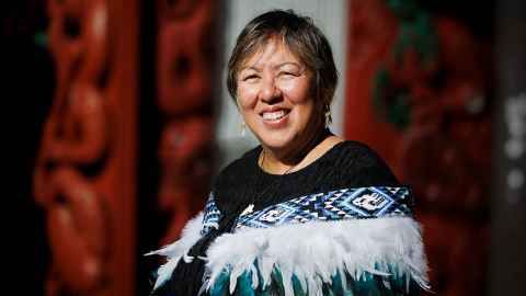 Photo of Josephine Davis in her regalia. She is standing outside Waipapa Marae. 