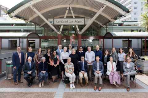 Photograph of Academic Staff outside of the Auckland Law School building.