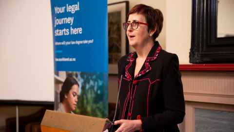 academic standing at a lectern 