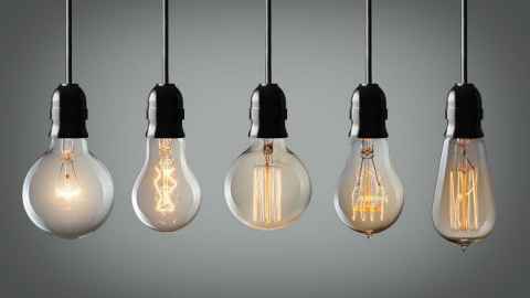 Different filament light bulbs hanging in a row 