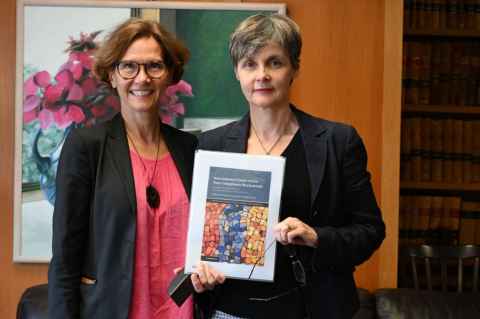 Professor Caroline Foster and Professor Christina Voigt with their book.