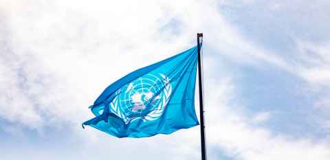 United Nations flag against blue sky