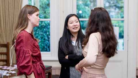 Three young women in conversation.