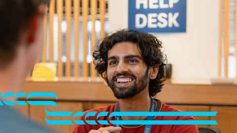 A photo of a Student Hub Adviser talking with a student.