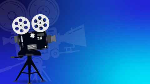 Image of video camera on tripod on blue background