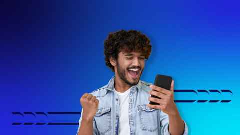 Photo of a student holding a phone with an excited expression