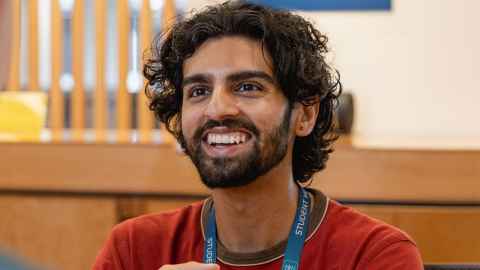 A smiling, friendly-looking person wearing a "Student Hub" lanyard