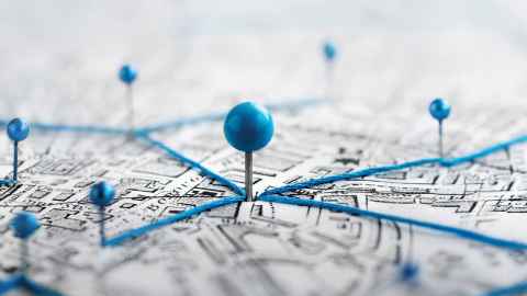 A map with blue pins in it that are connected by blue string.