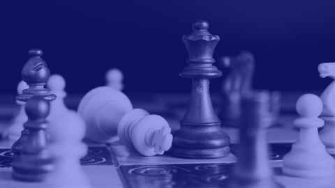 Blue-toned image of chess pieces on a chess board