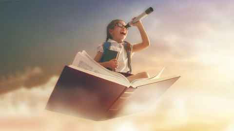 Creative image of young girl coming out of a book floating in the clouds, while looking through telescope 