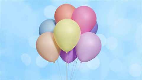 Graphic image of colourful balloons gathered together in a bunch against a sky blue background. 