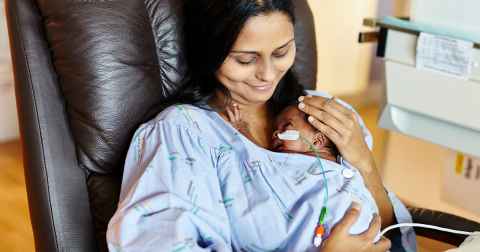 Mother holding her baby in NICU