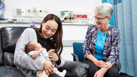 Distinguished Professor Dame Jane Harding with a mother and her baby