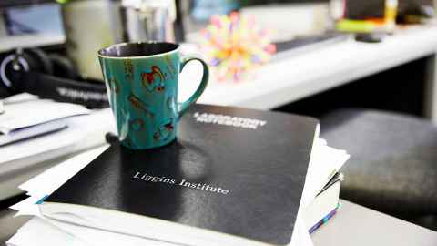 Coffee cup placed on Liggins Institute Laboratory Handbook