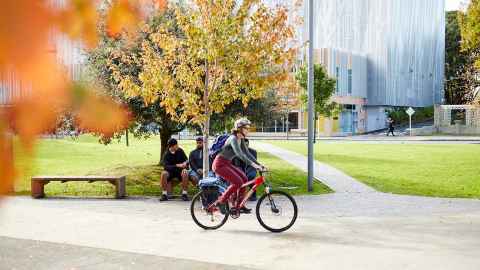 Student riding a bicycle on campus
