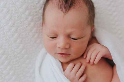 A baby lying on a mat