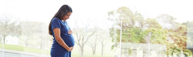 Pregnant woman holding her belly