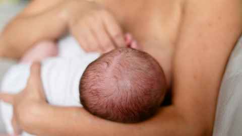 Mother breastfeeding newborn