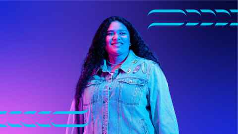 student smiling with purple background